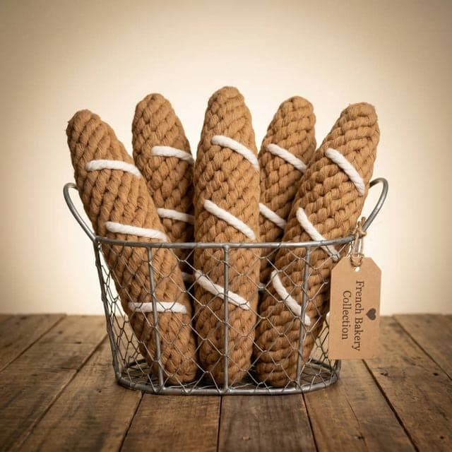 Rope baguette dog toys standing in a wire basket