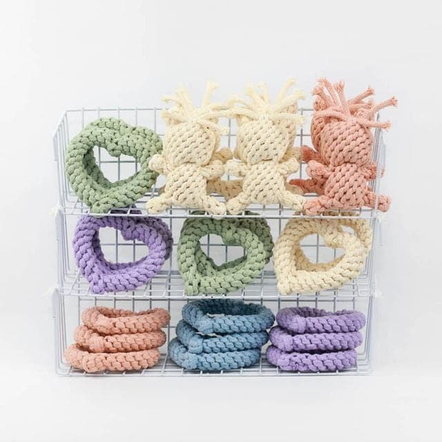Pastel rope macaron and bear dog toys in a wire display rack