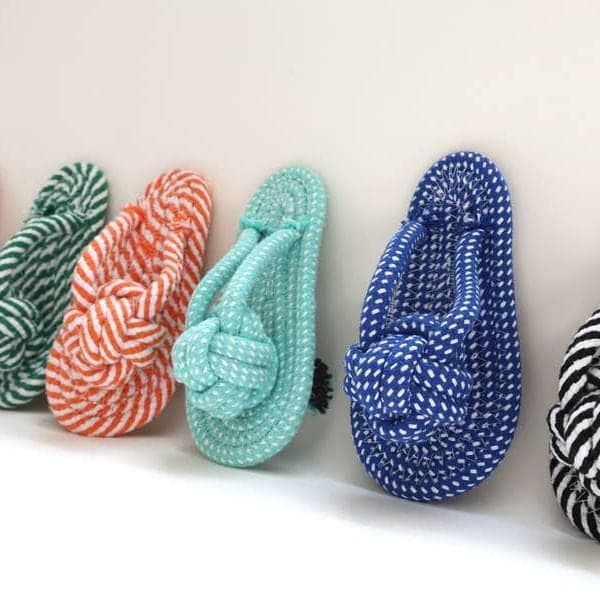 Coral, mint and blue rope slipper dog toys in a row
